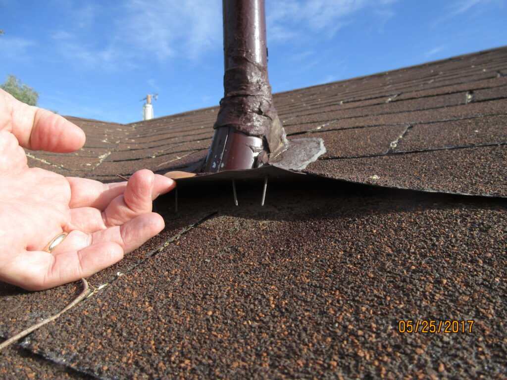 Photo of loose flashing on a roof.